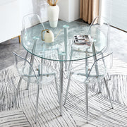 Table and chair set.A 38.6' Transparent Tempered Glass Round Dining Table-Silver Metal Legs.Paired with 4 Transparent Plastic Dining Chair with Silver Metal Legs.