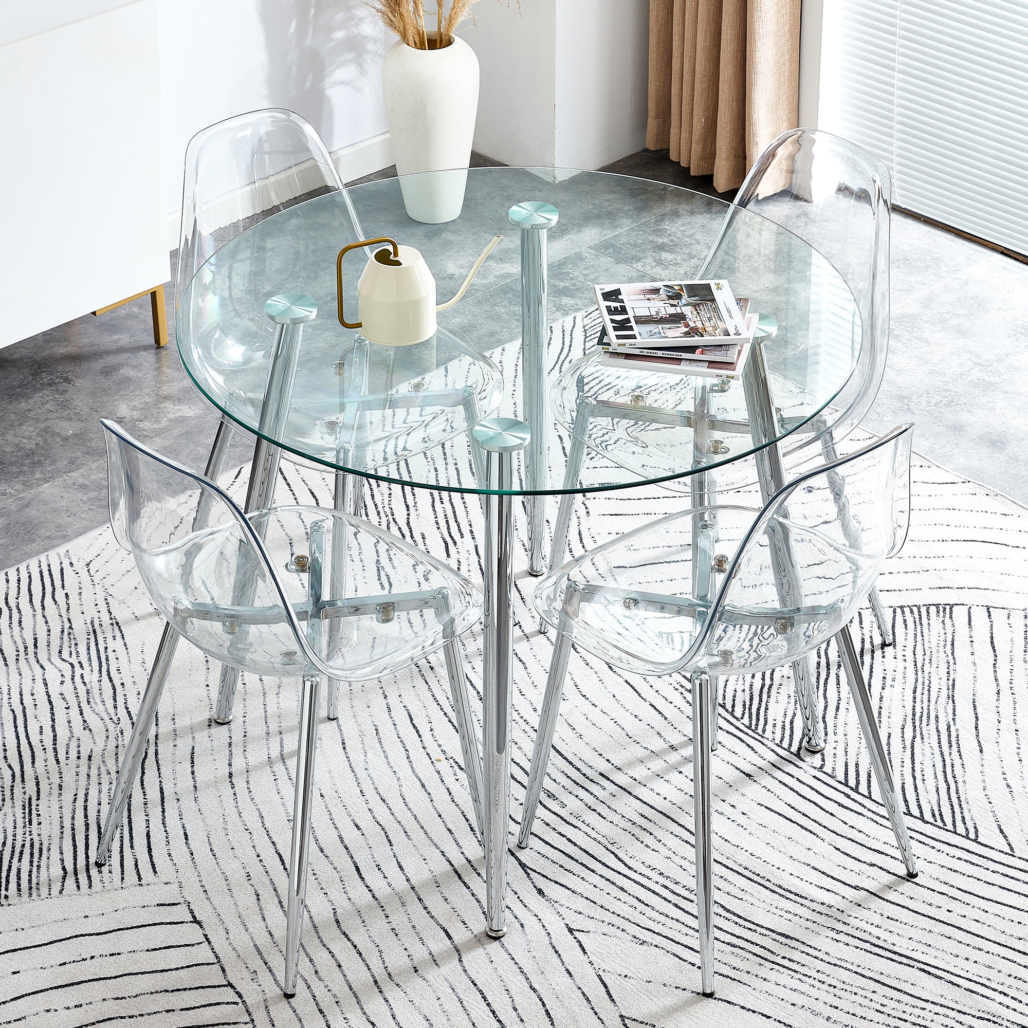 Table and chair set.A 38.6' Transparent Tempered Glass Round Dining Table-Silver Metal Legs.Paired with 4 Transparent Plastic Dining Chair with Silver Metal Legs.