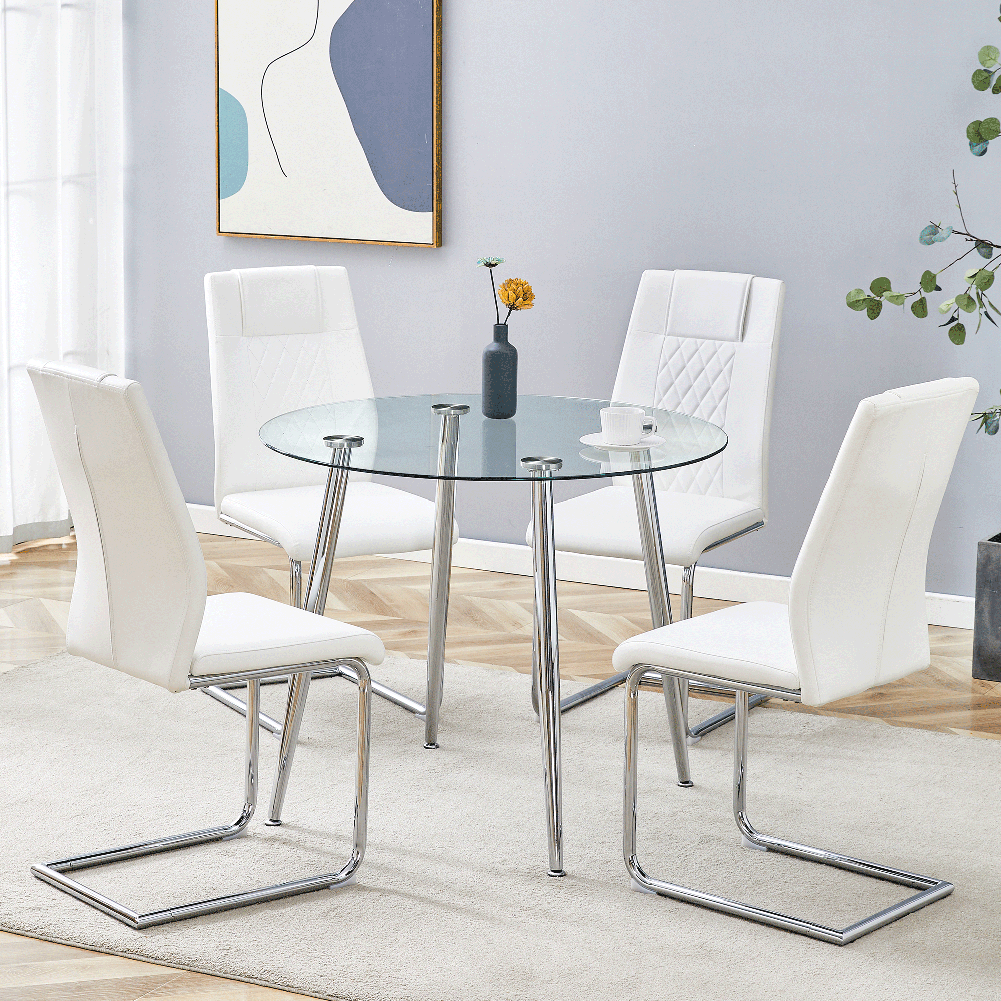 A modern minimalist round transparent tempered glass table with silver metal legs and 4 white modern PU leather high-backed dining chairs for a luxurious experience.