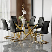 Table and chair set.Modern Luxurious Transparent Tempered Glass Dining Table Set with 6 Chairs.Double Forked Golden Metal Table Legs.Black high-quality PU dining chairs with golden metal legs.