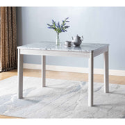 Faux marble white dining table top Four rounded leg posts Rounded table corners White Oak leg color