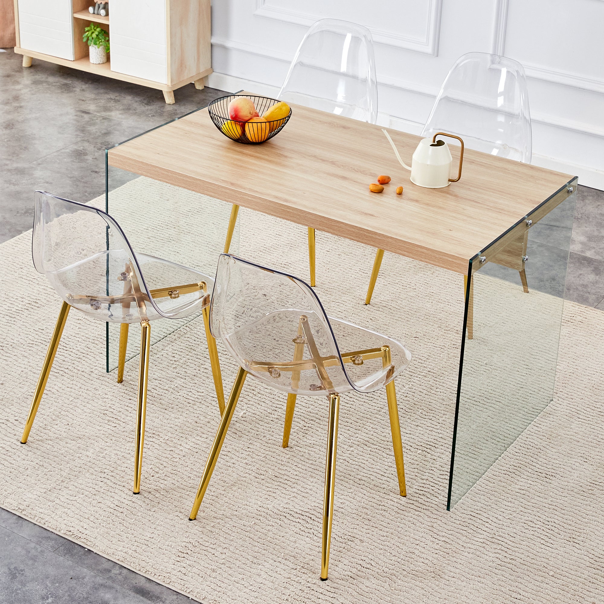 Table and chair set.Wood Texture MDF Coffee Table - Reinforced with Tempered Glass Legs.Paired with 4 Transparent Plastic Dining Chair with Gold Cross Base Legs.